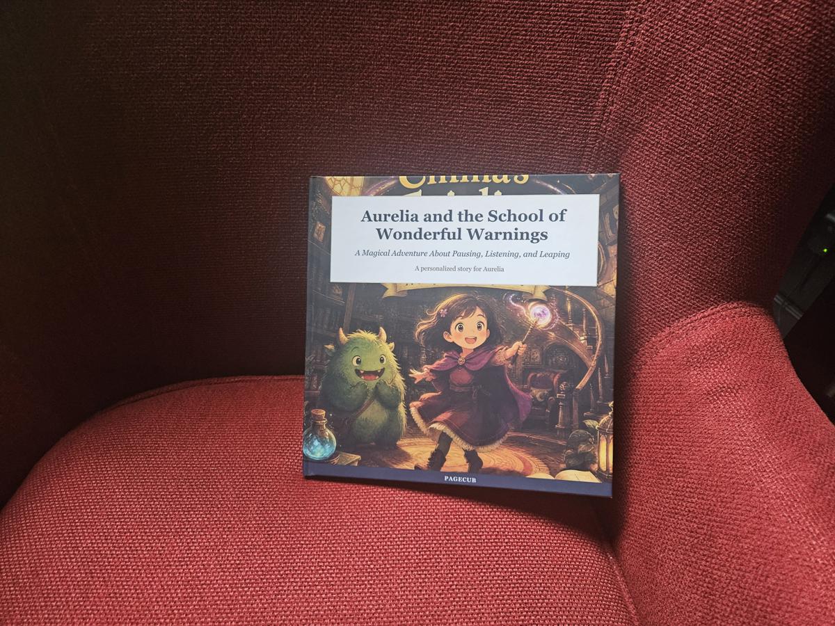 A PageCub hardcover book displayed on a cushion