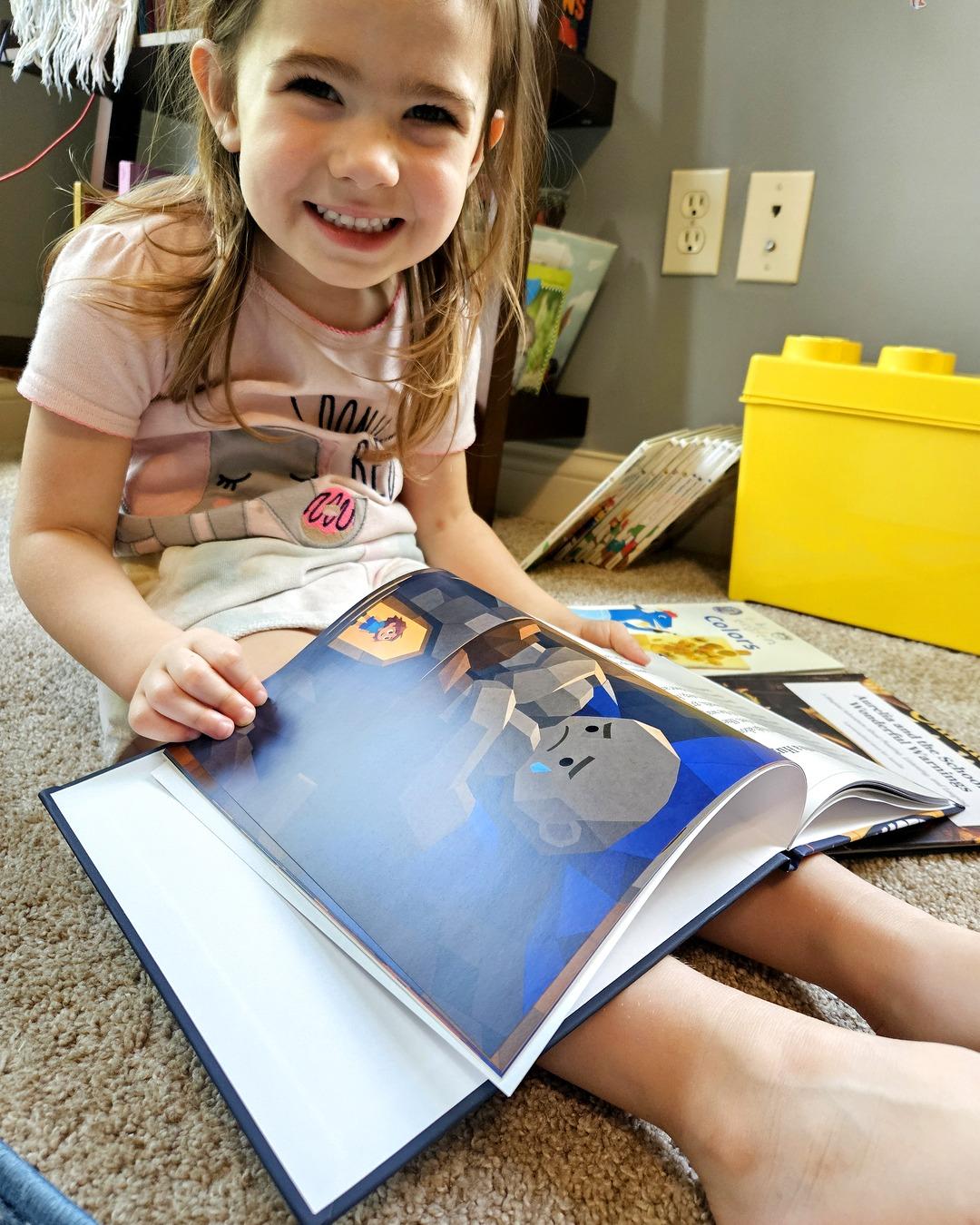 A child smiling genuinely at her personalized PageCub storybook